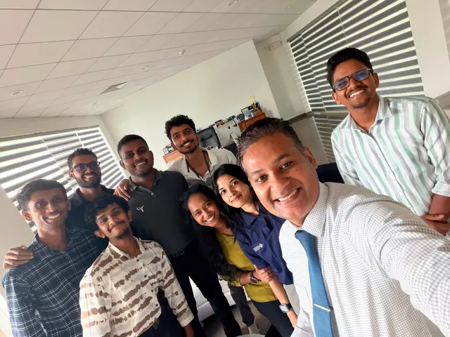 A selfie of the student organisers with a faculty member in his office